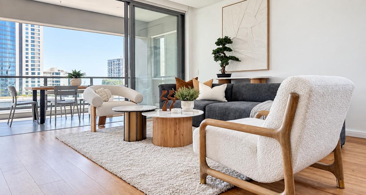 Lounge with boucle chairs opening onto a balcony